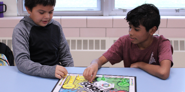 students play board game