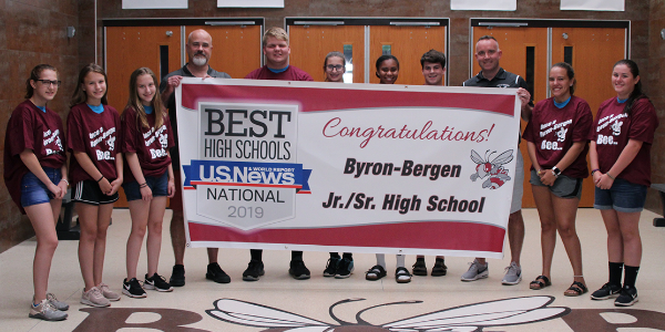 Students and staff with banner