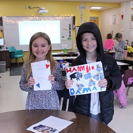 students hold get-well-soon cards