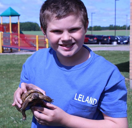 student with tortoise 