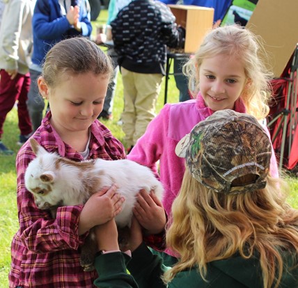 student holding a goat