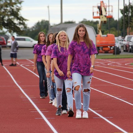 Cross Country team entering track 