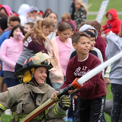 student uses fire hose