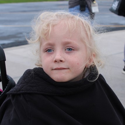 student in front of school
