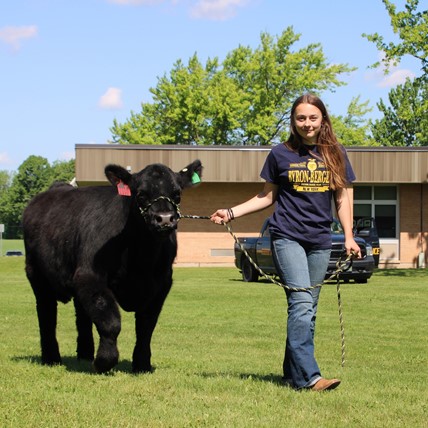 student with cow