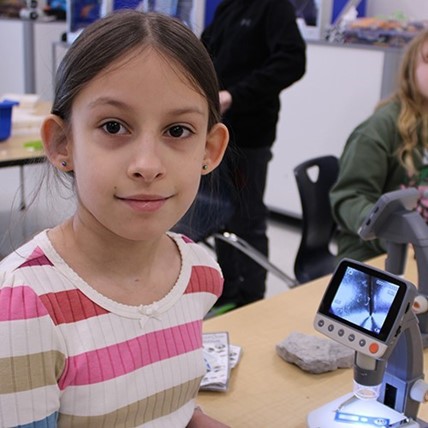 student with microscope